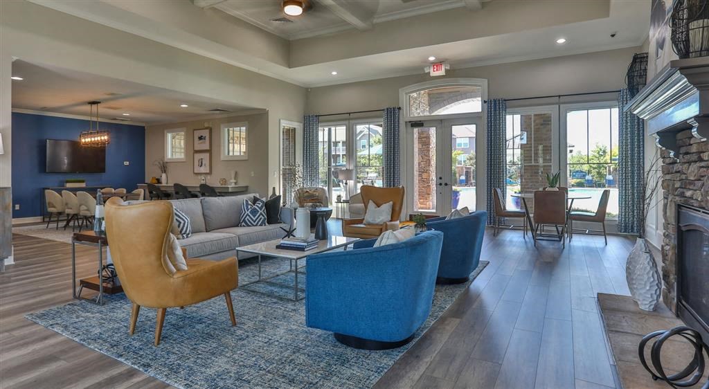 a living room with couches and chairs and a fireplace