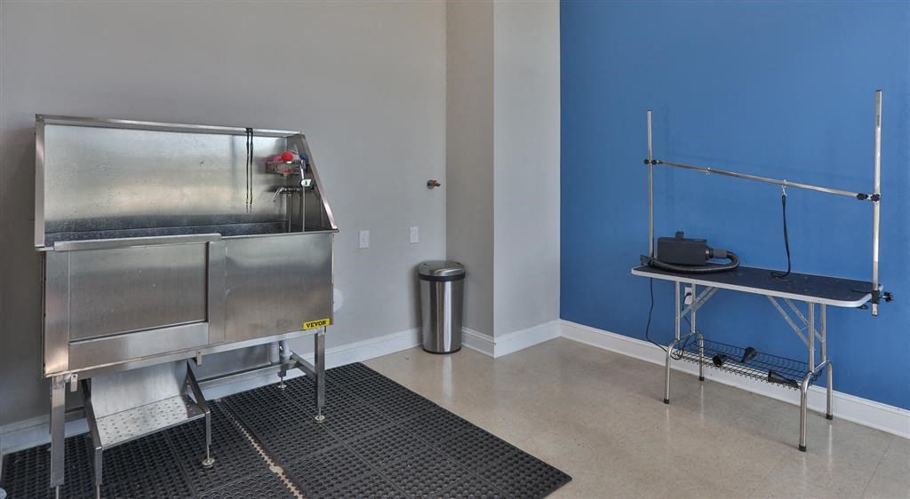 a room with a stainless steel refrigerator and a table