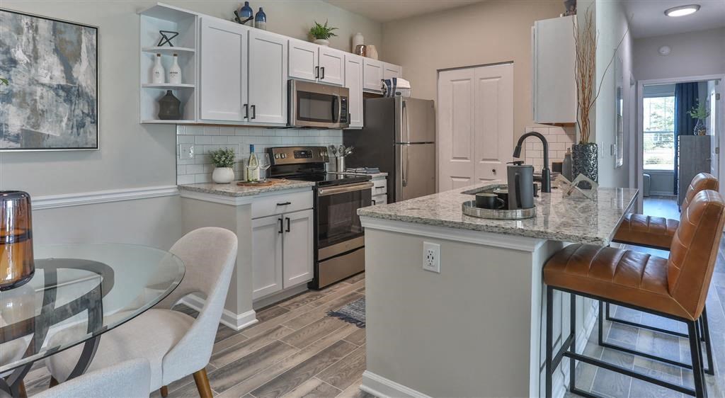 a kitchen and dining room with a table and chairs