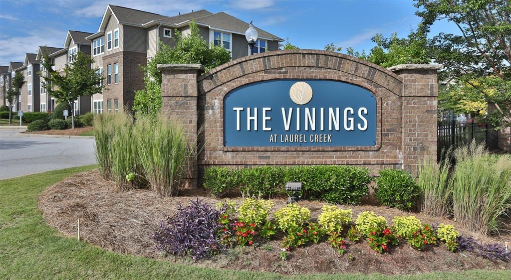 a sign for the vinings in front of a building
