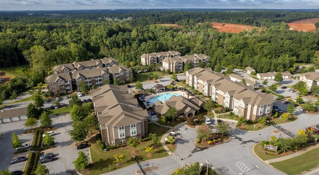an aerial view of a neighborhood with houses and a swimming pool
