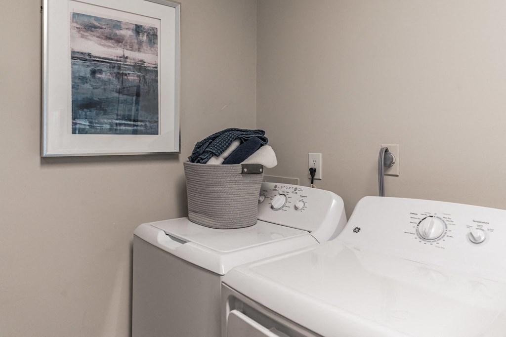 a washer and dryer in a laundry room with a sink