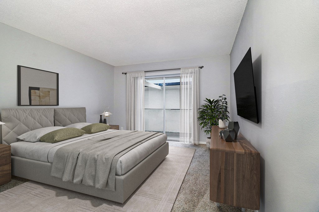 a bedroom with a bed and a tv on the wall