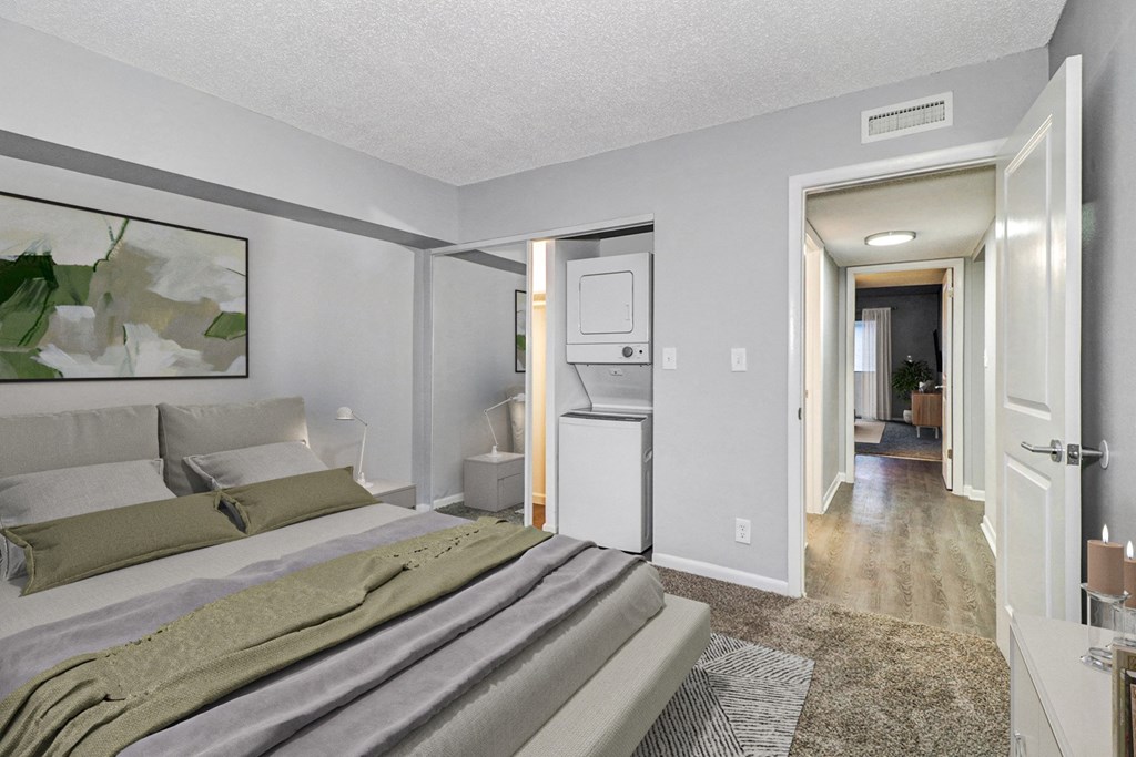 a bedroom with a large bed and a closet and a bathroom