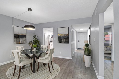 a dining room with a glass table and chairs