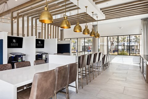 A restaurant with white tables and brown chairs.