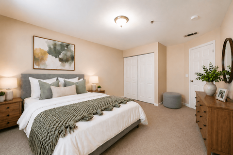 A bedroom with a large bed and a painting on the wall.
