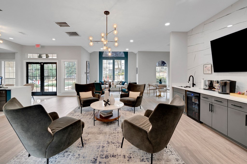 a living room with chairs and a table and a television