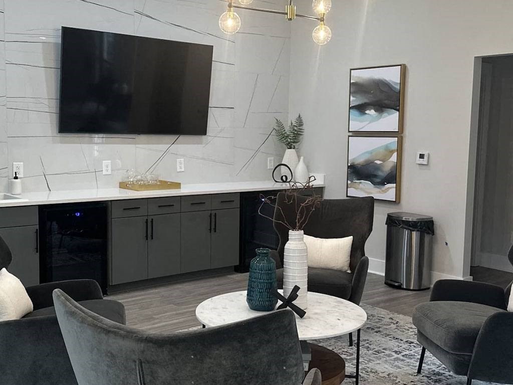 a living room with a table and chairs and a television