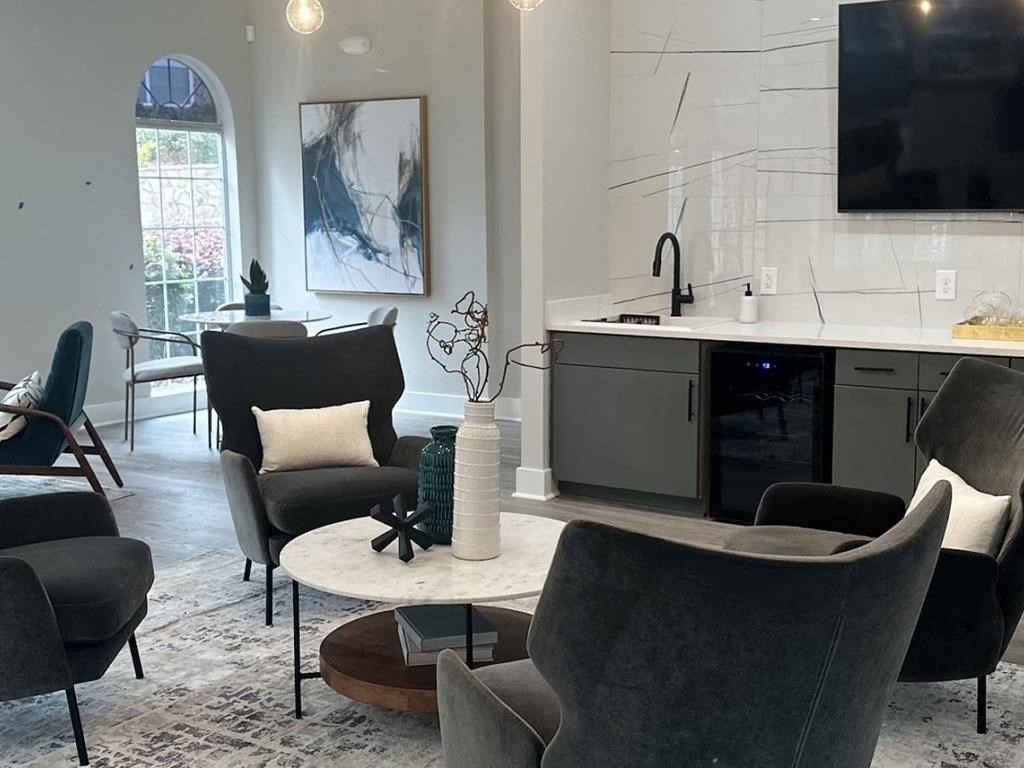 a living room with a kitchen and a table and chairs