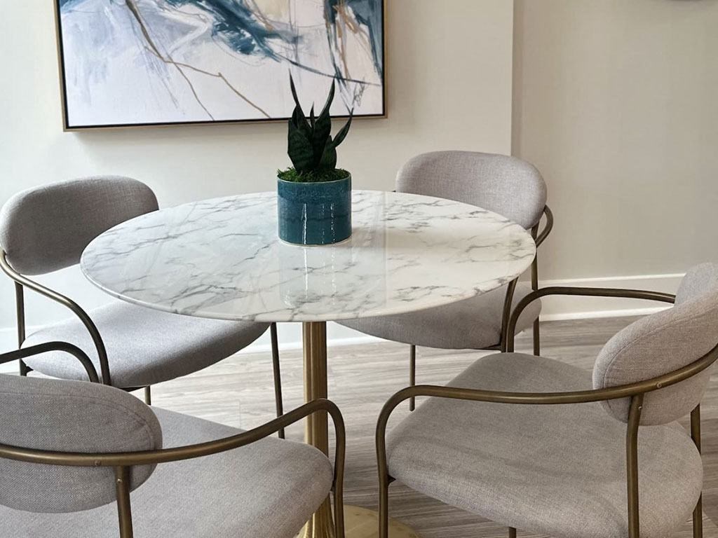a round table with chairs and a potted plant on it