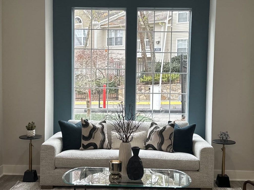 a living room with a couch and a glass table