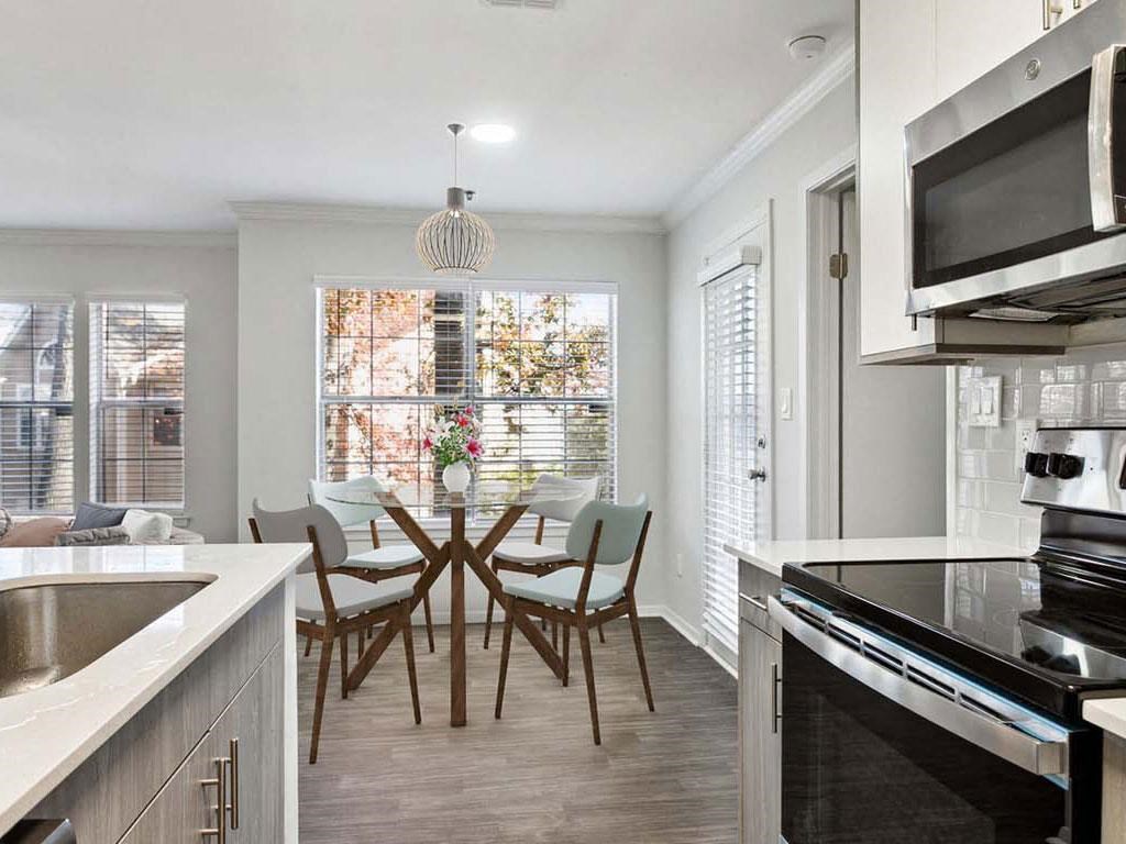 a kitchen and dining room with a table and chairs