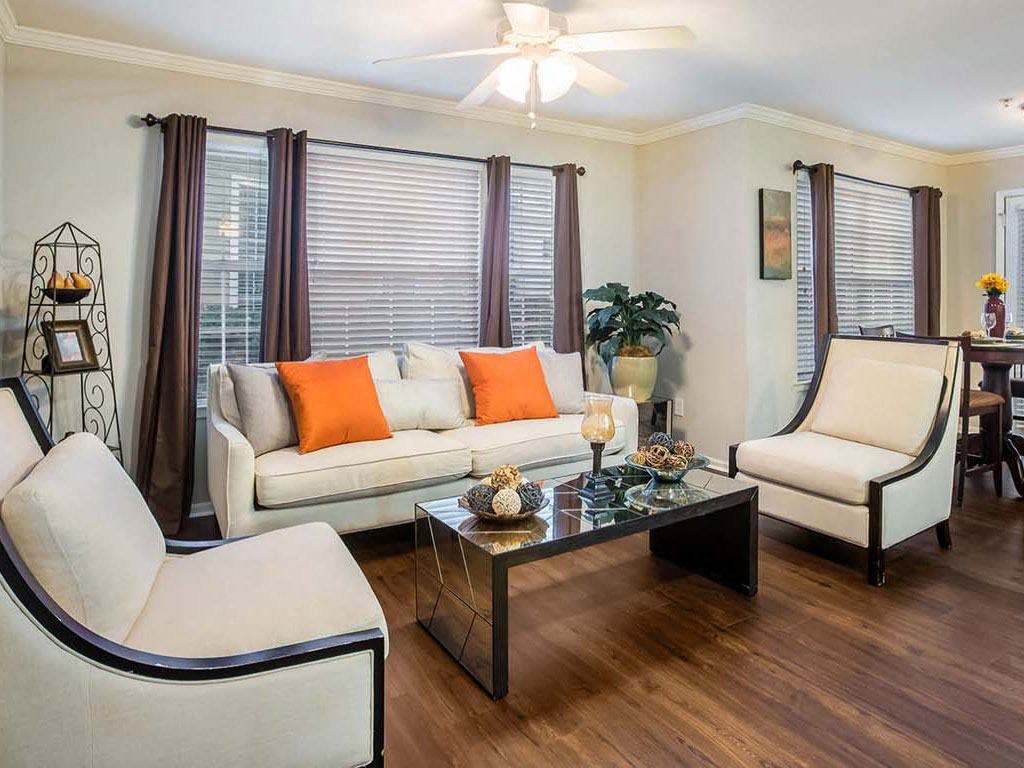 a living room with a couch and chairs and a table