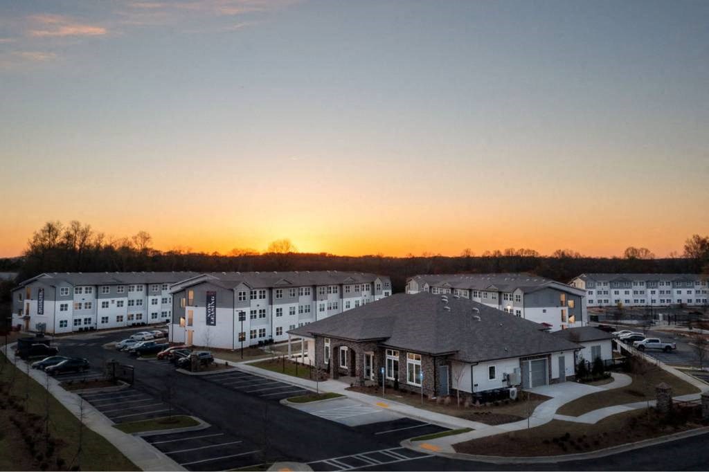 an aerial view of an apartment complex at sunset