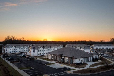 an aerial view of an apartment complex at sunset