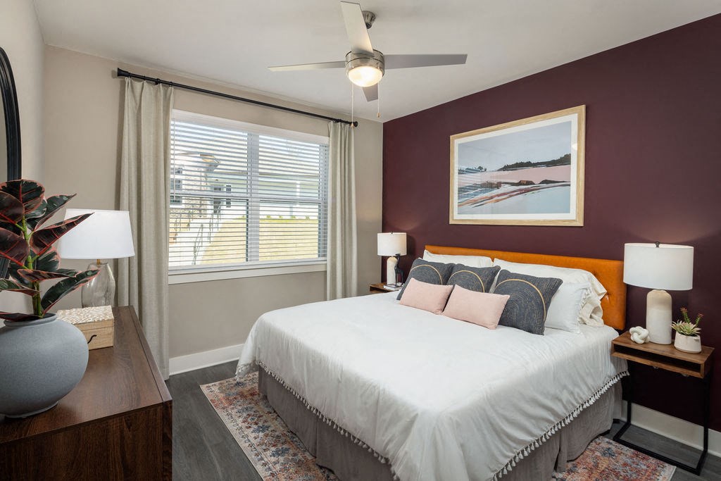 a bedroom with a bed and a ceiling fan