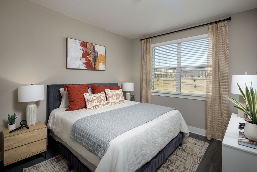 a bedroom with a bed and a large window