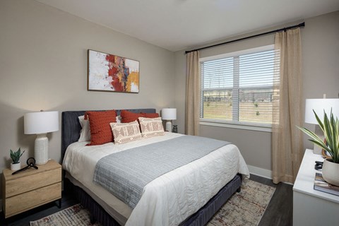 a bedroom with a bed and a large window