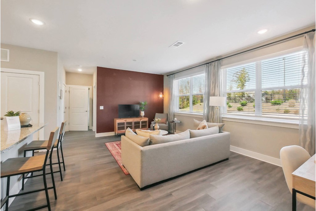 a living room with a couch and a table with chairs
