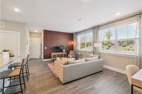 a living room with a couch and a table with chairs