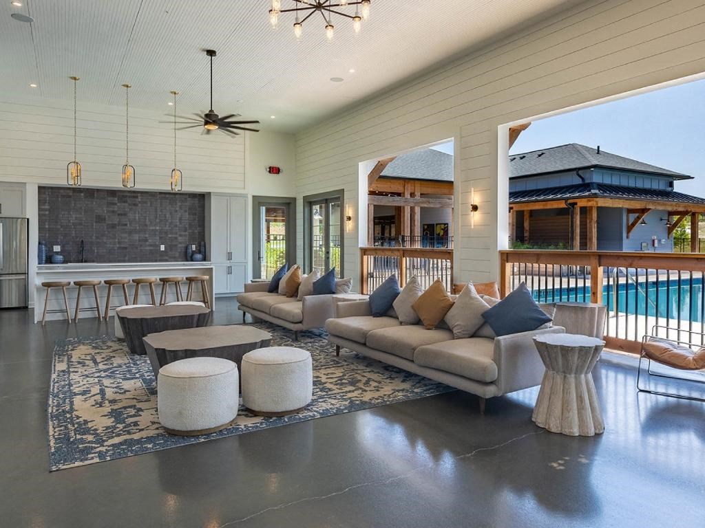 a living room with a couch and a bar and a pool