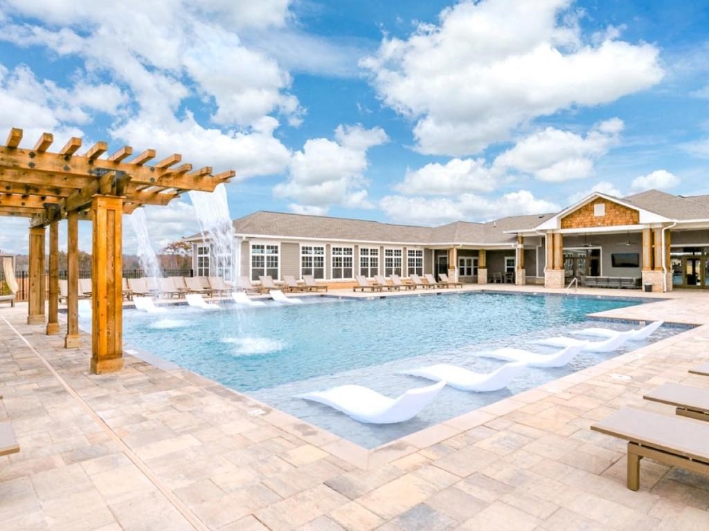 a large swimming pool with a building in the background