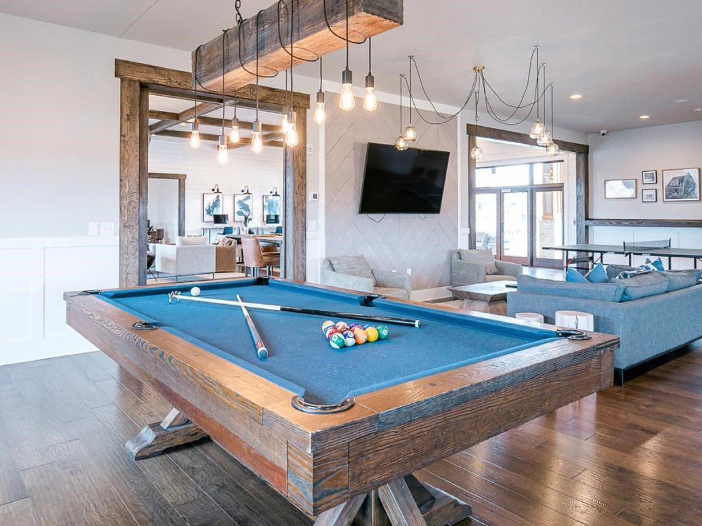 a pool table in a living room with a tv