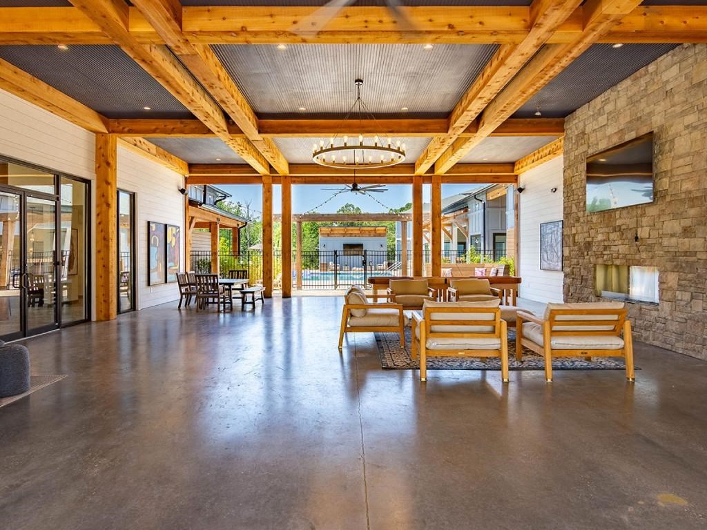a large living room with a table and chairs and a fireplace