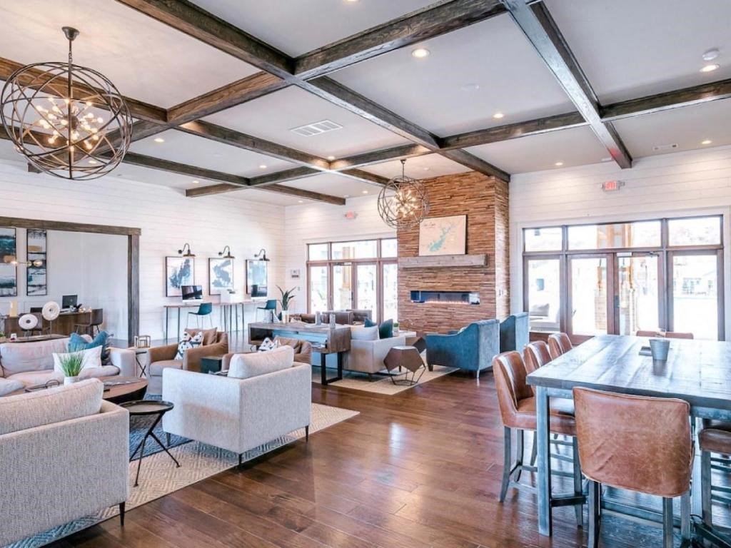 a large living room with couches and chairs and a table