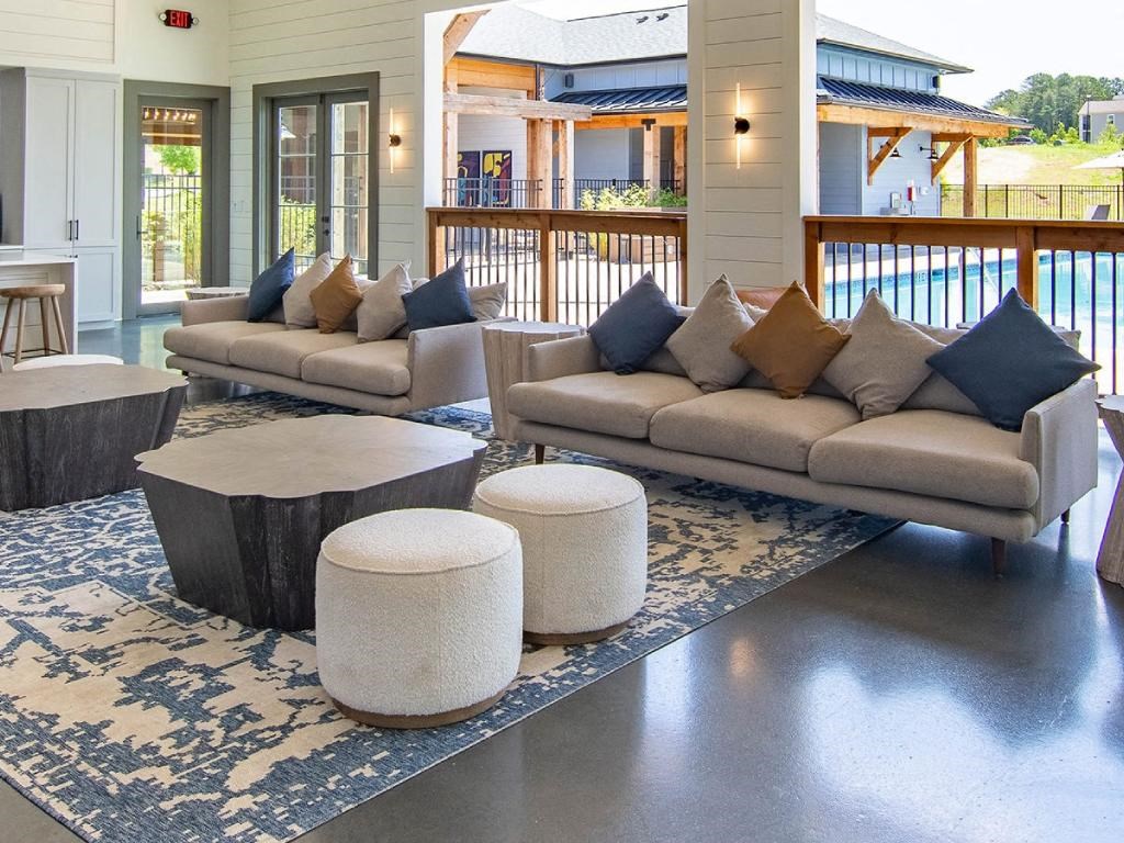 a living room with couches and tables on a rug
