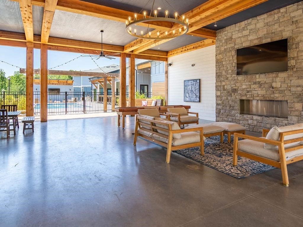 a large living room with a fireplace and a table and chairs