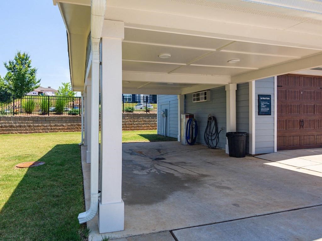 a covered parking lot with bikes parked under a covered porch