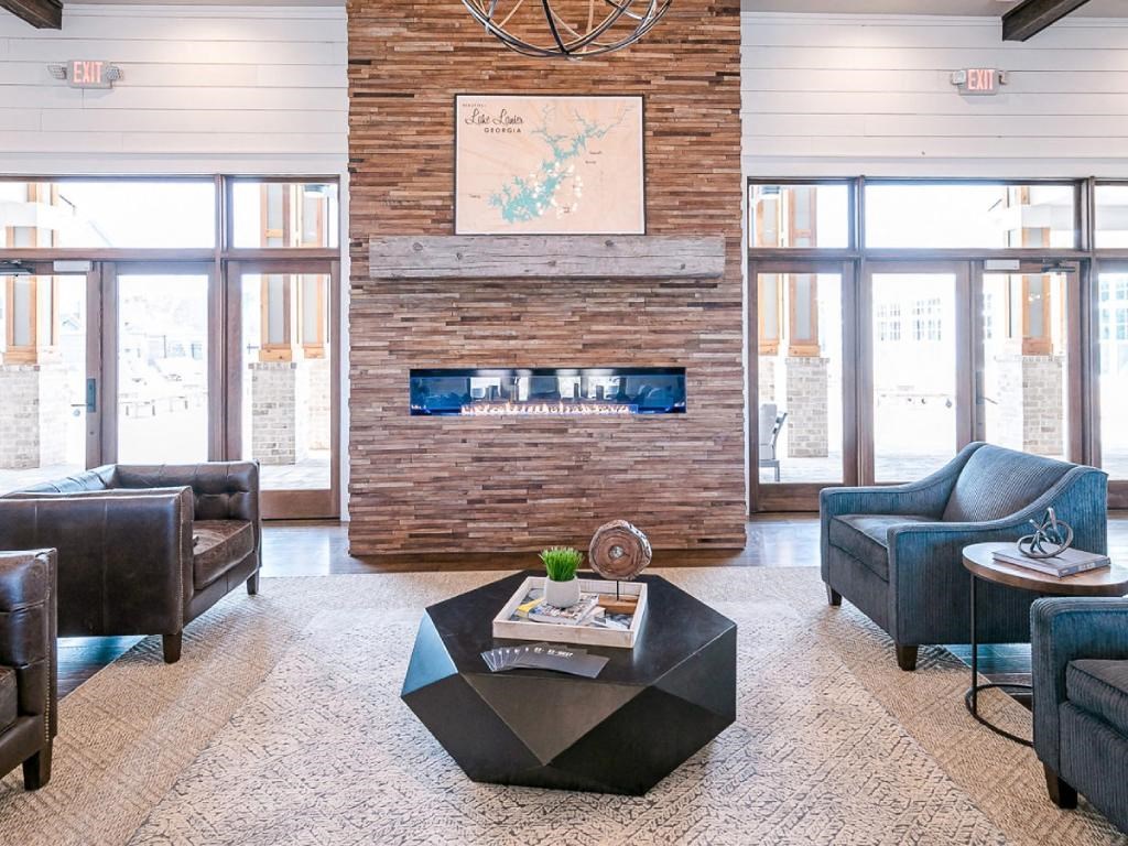 a living room with couches and a coffee table in front of a fireplace