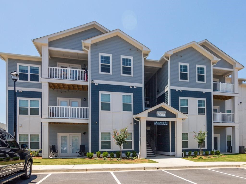 an apartment building with a car parked in front of it