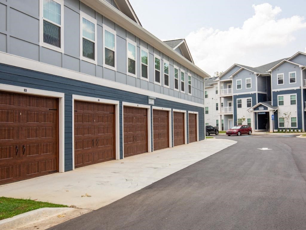 a row of garages in front of an apartment building