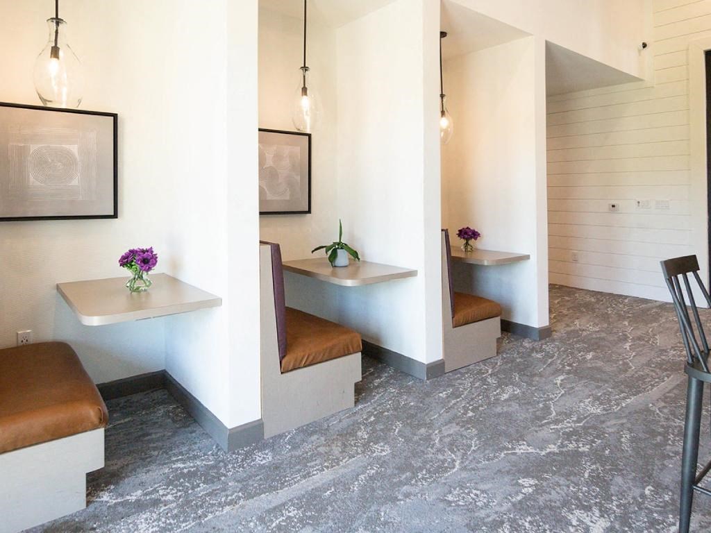 a conference room with benches and tables and chairs