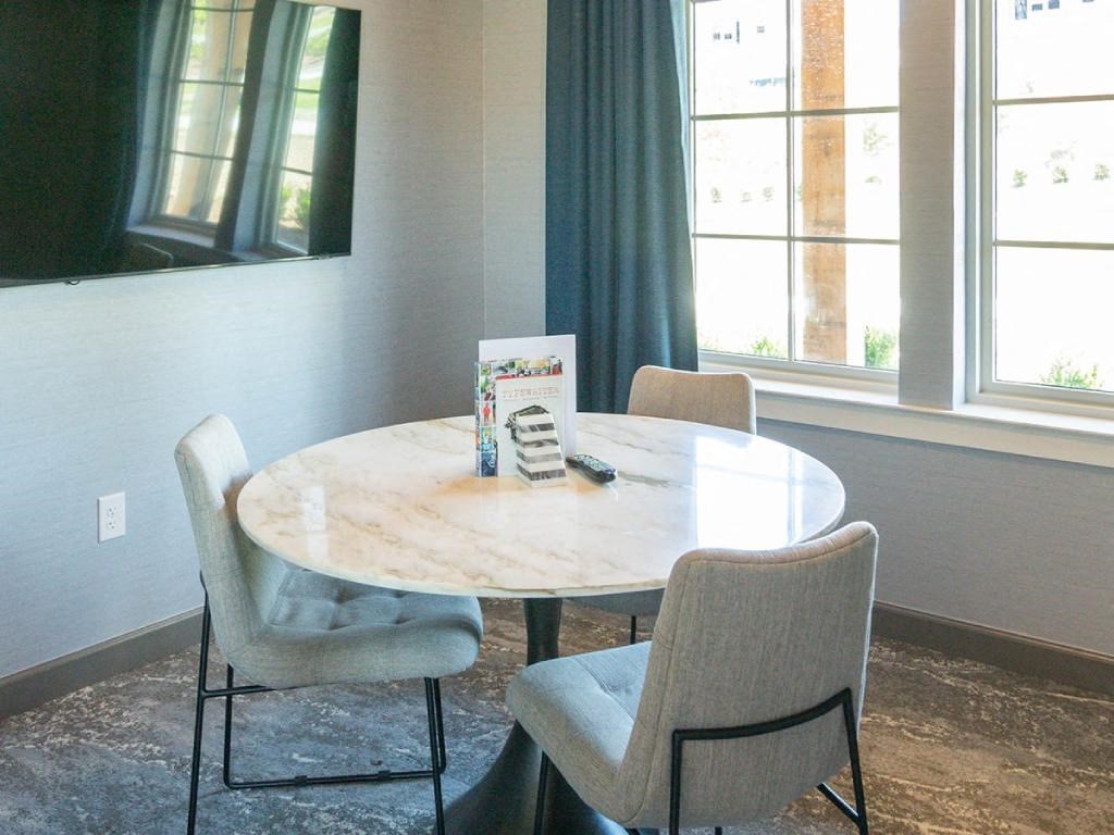 a dining room table with chairs and a book on it