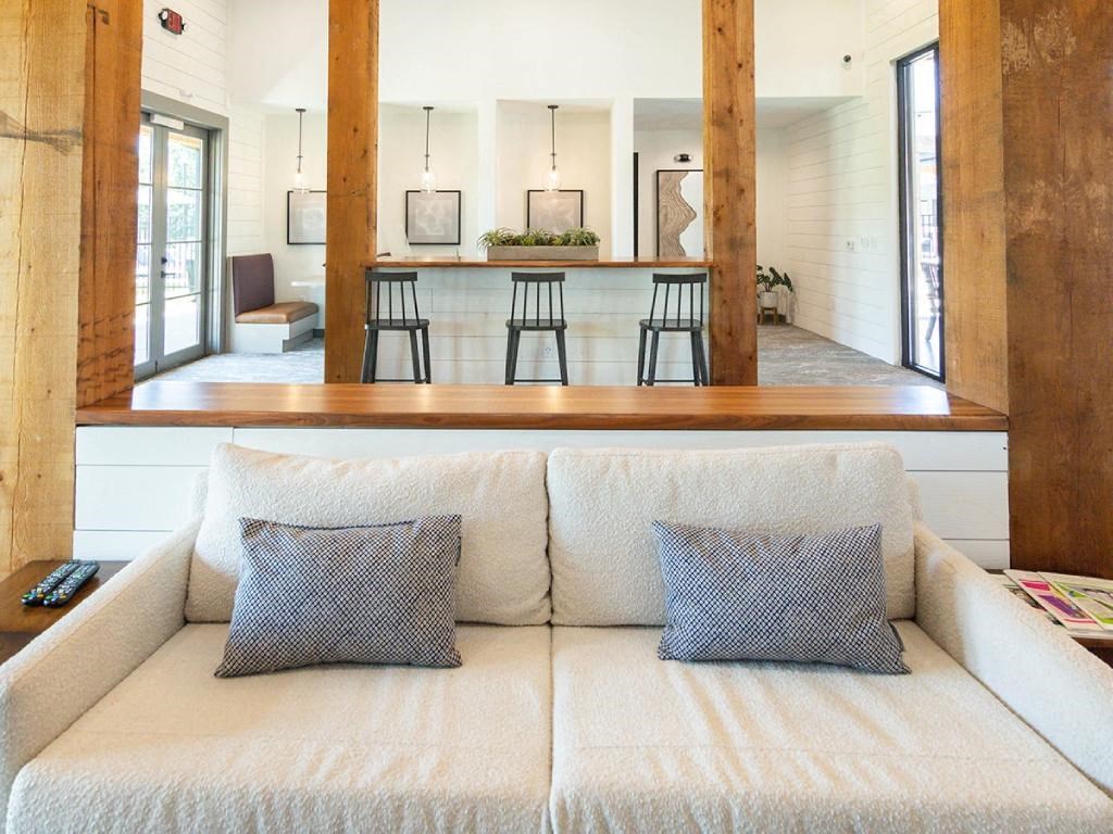 a living room with a couch and a kitchen in the background