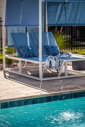 a swimming pool with a reflection of a chair in it