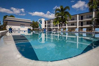 a large swimming pool in front of a building