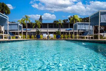 a large swimming pool in front of a building