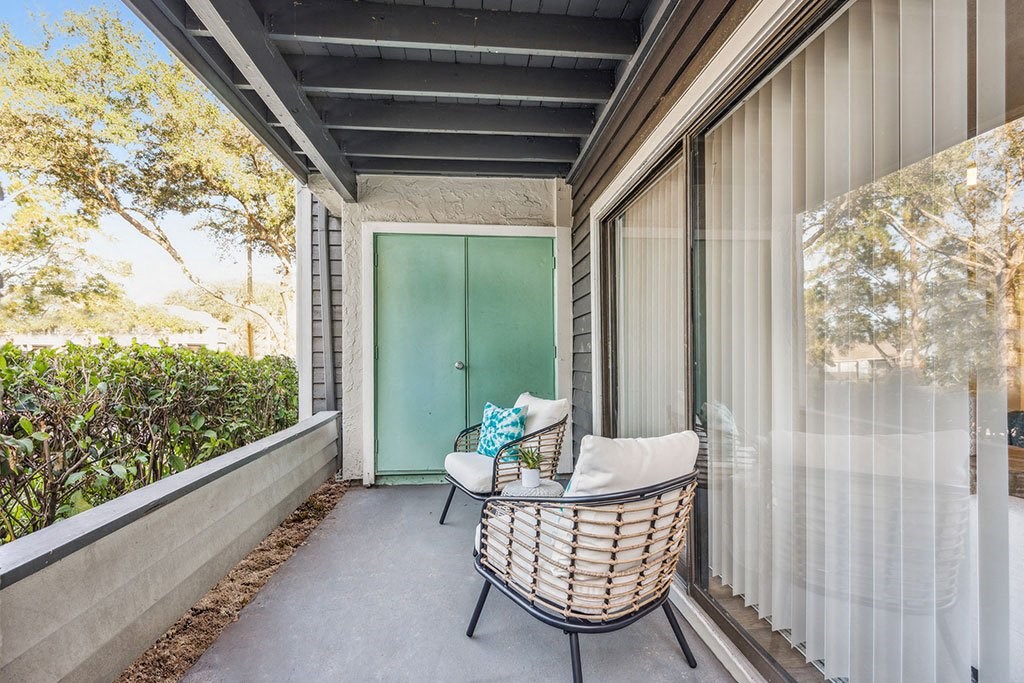 a porch with a chair and a table