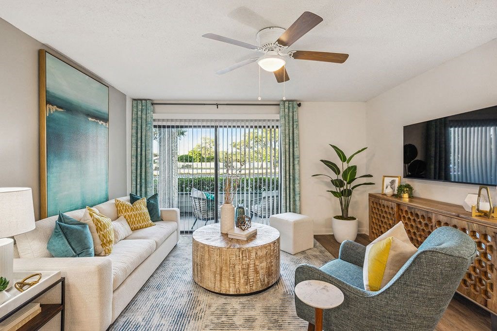 a living room with furniture and a ceiling fan