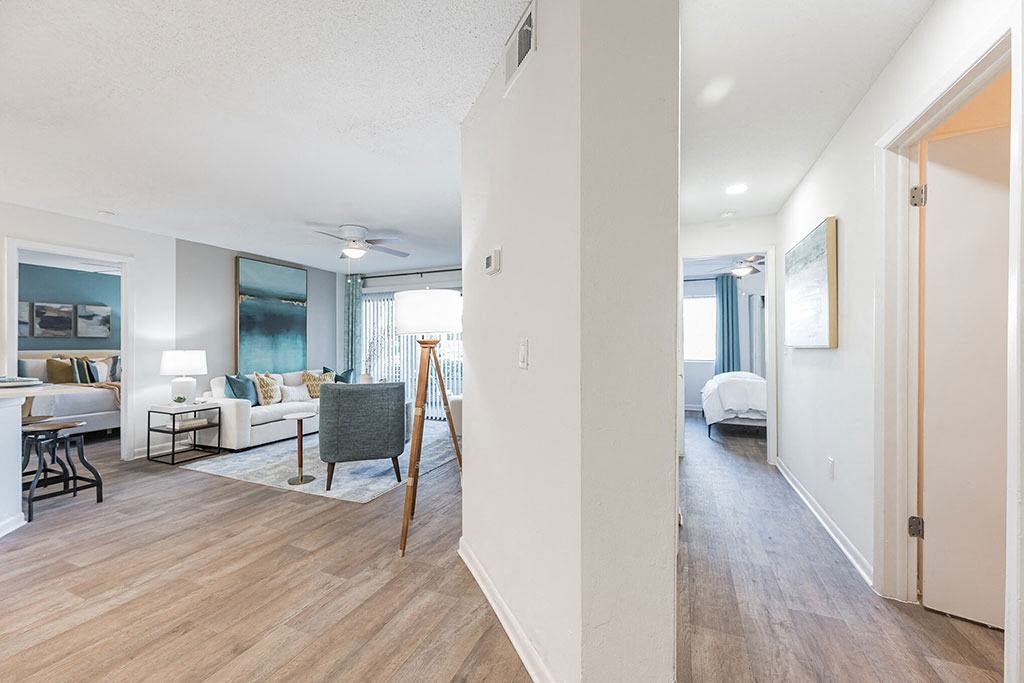 a living room and dining room with a wood floor