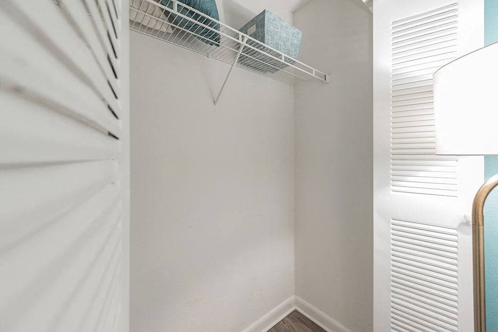 a closet with white walls and a white closet door