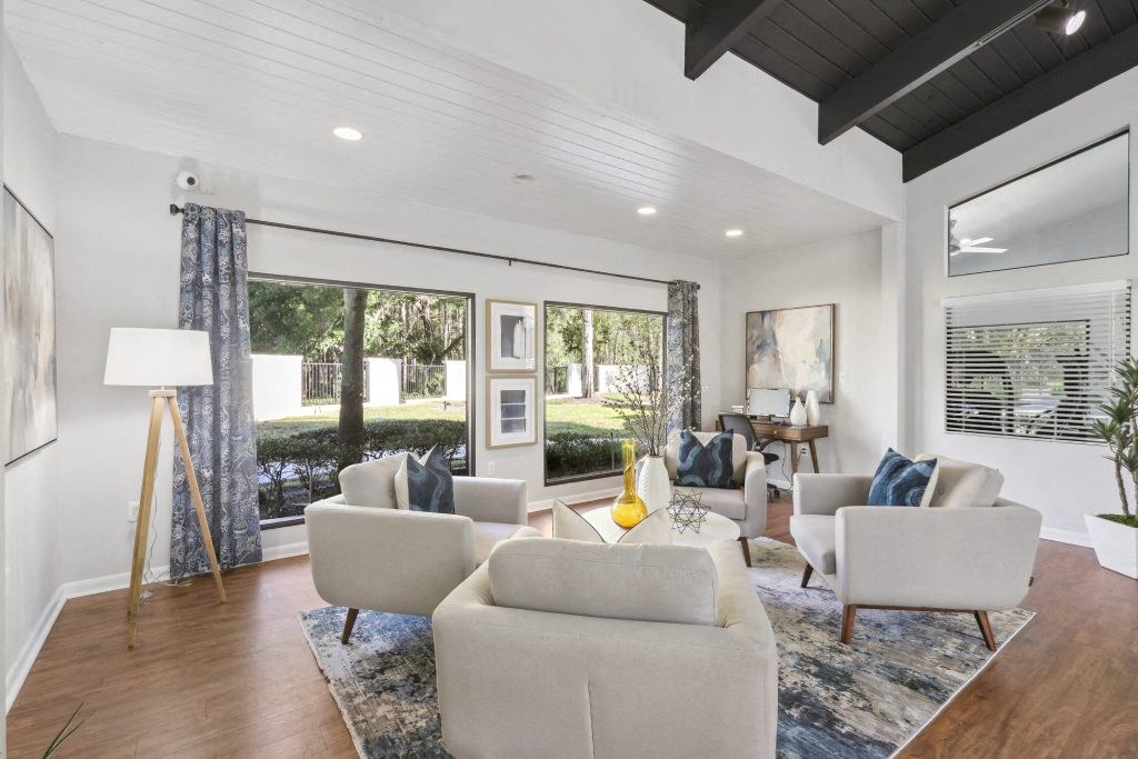 a living room with couches and chairs and sliding glass doors