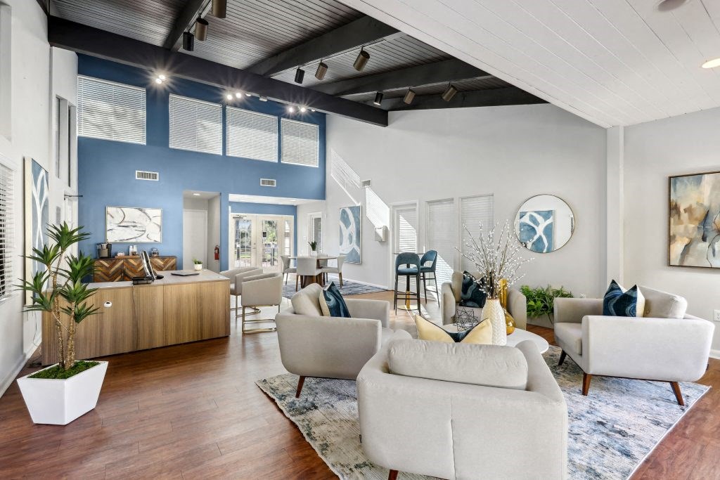 a living room and dining room with couches and a rug