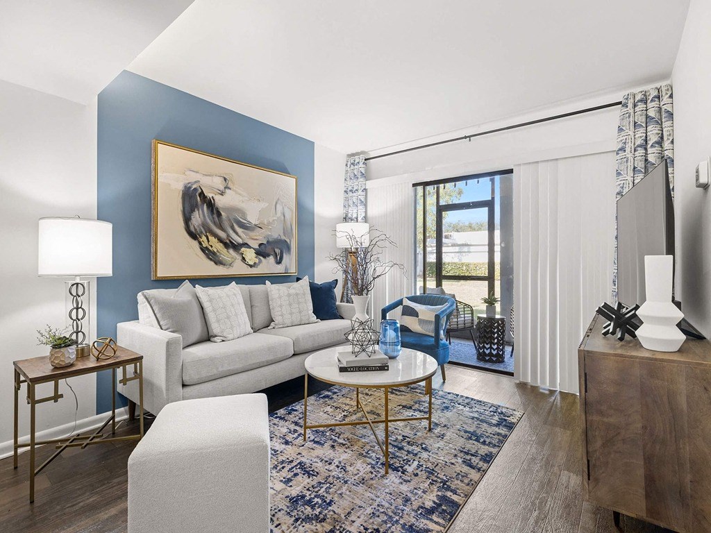 a living room with blue walls and a sliding glass door to a patio
