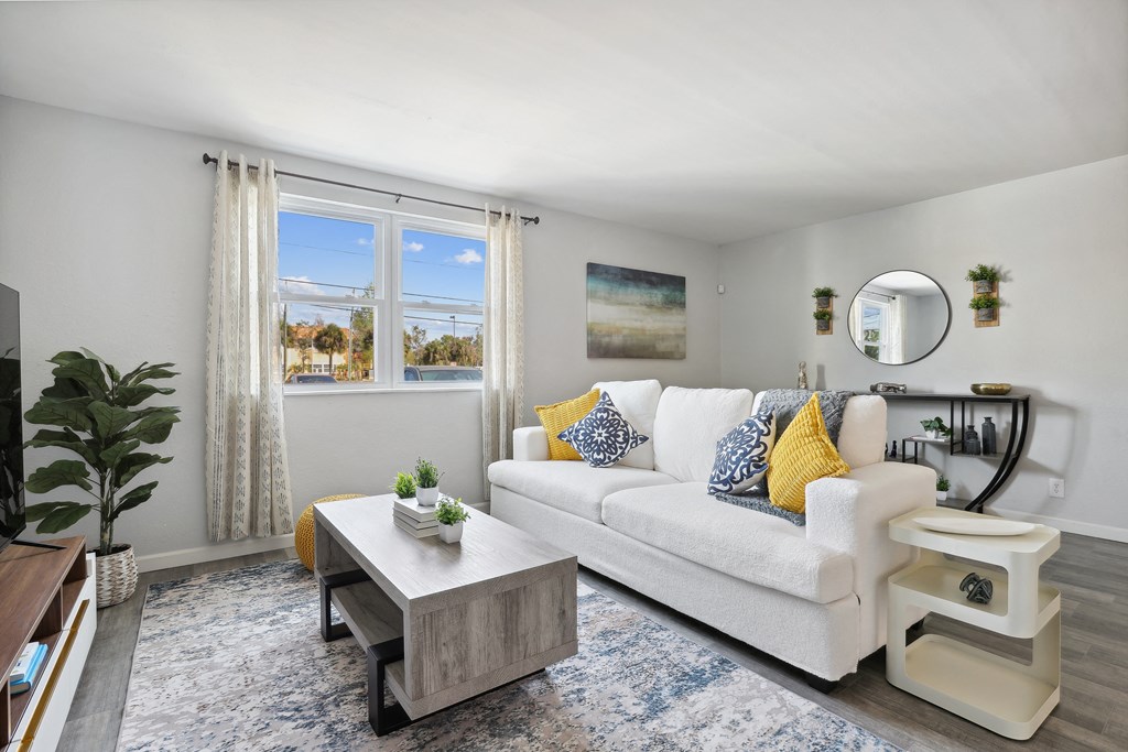 a living room with a white couch and a coffee table